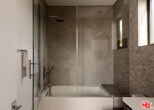 a bathroom with a bathtub and a shower