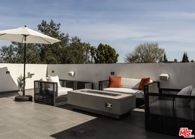 a view of a terrace with furniture and stove