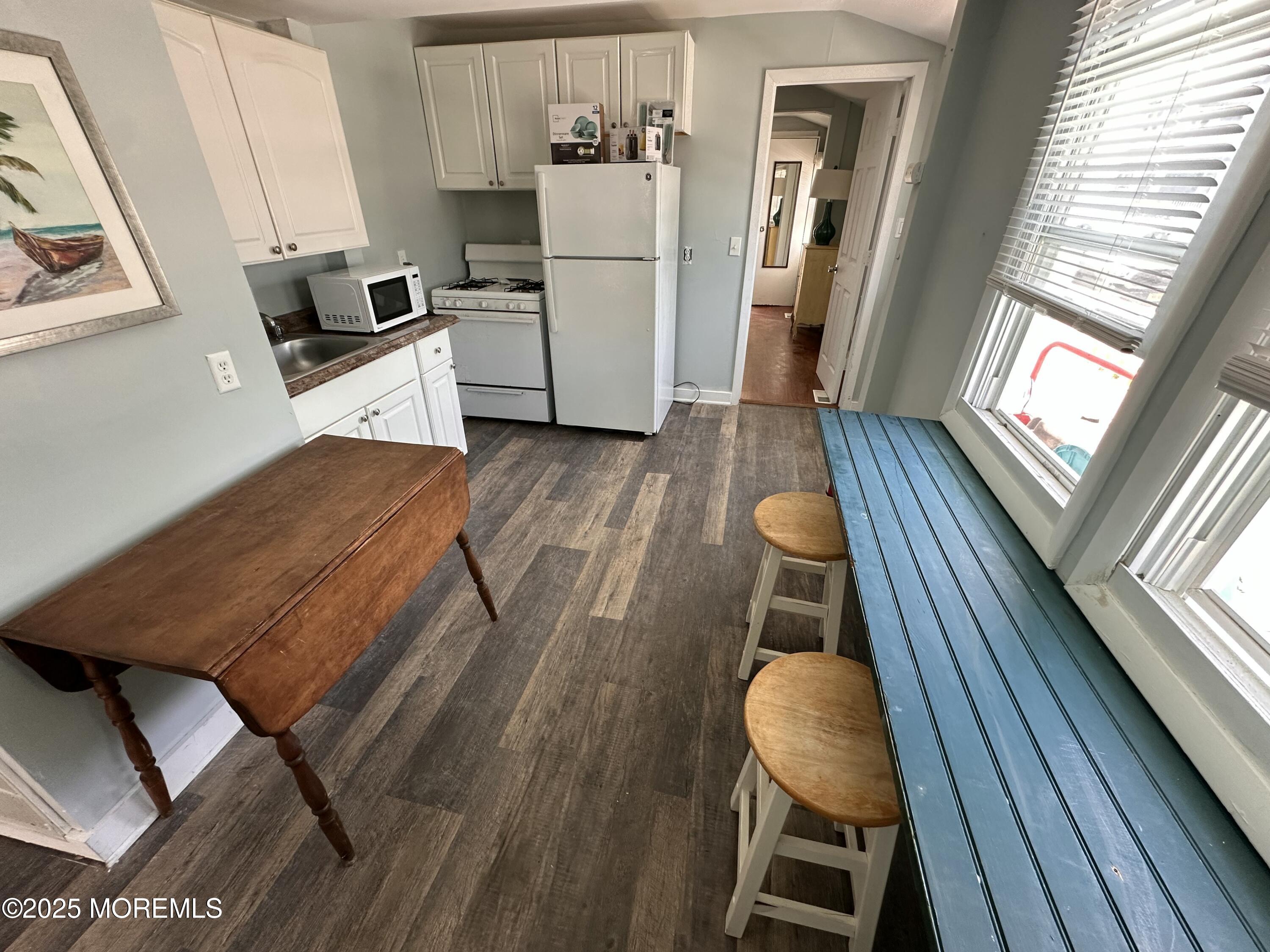 116 12th Avenue, Unit A Belmar, NJ 07719 - Photo 1 of 4 a kitchen with wooden floors and refrigerator