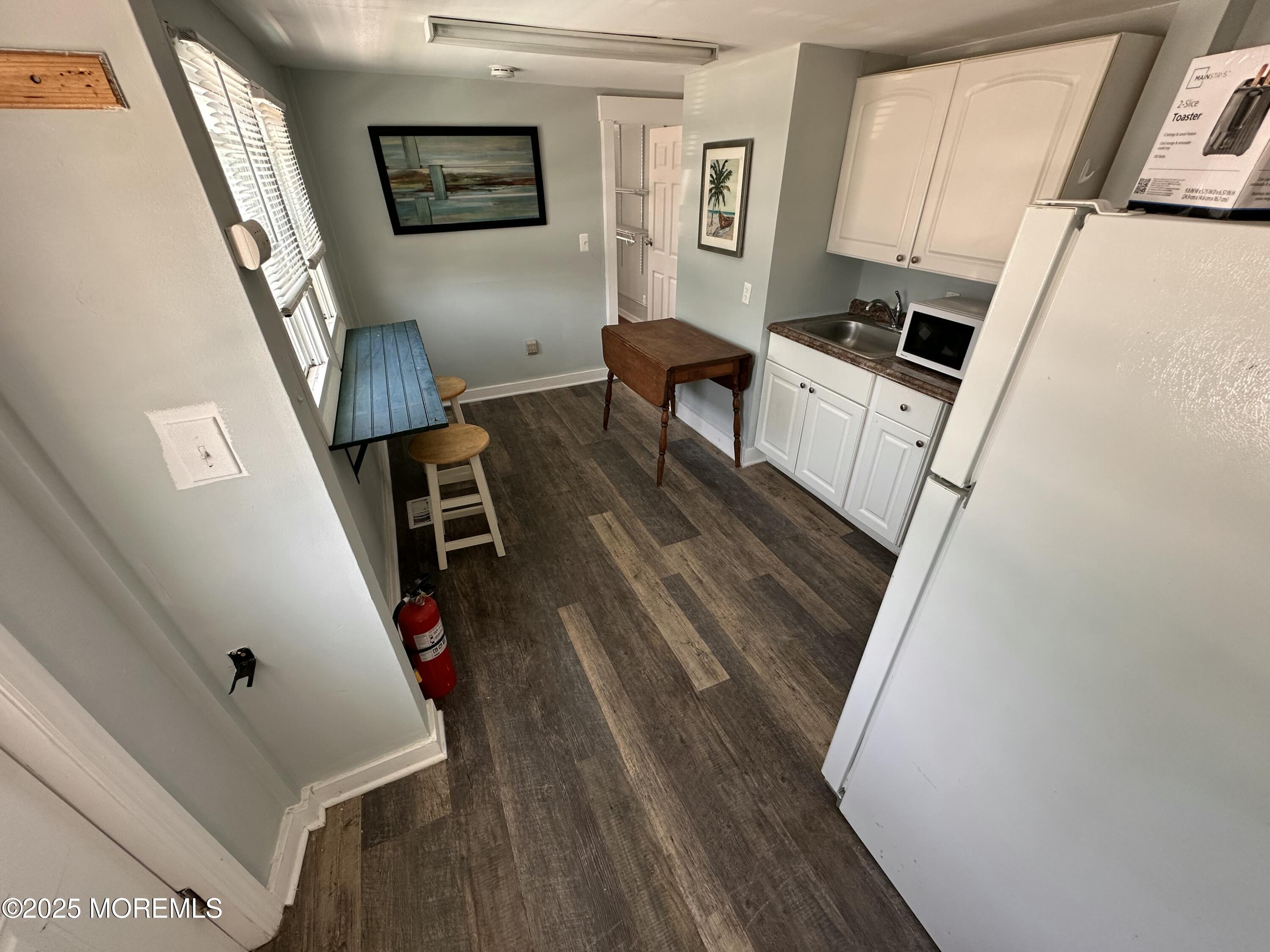 116 12th Avenue, Unit A Belmar, NJ 07719 - Photo 2 of 4 a living room with furniture and a fireplace