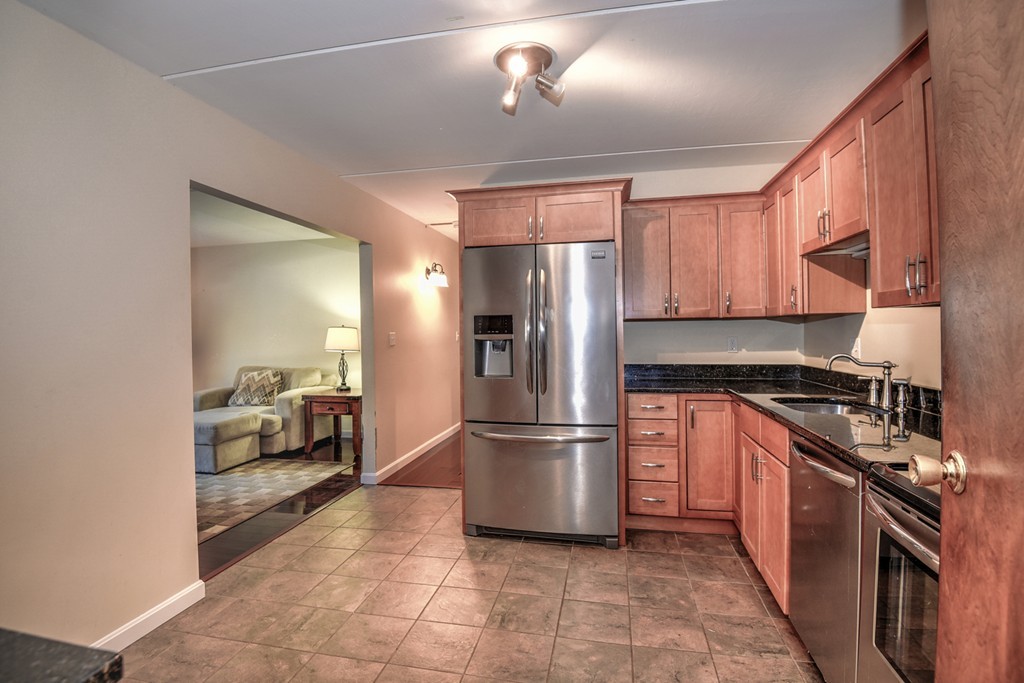 20 Lawrence Road, Unit 6 Rowley, MA 01969 - Photo 3 of 17 a kitchen with a refrigerator and a sink