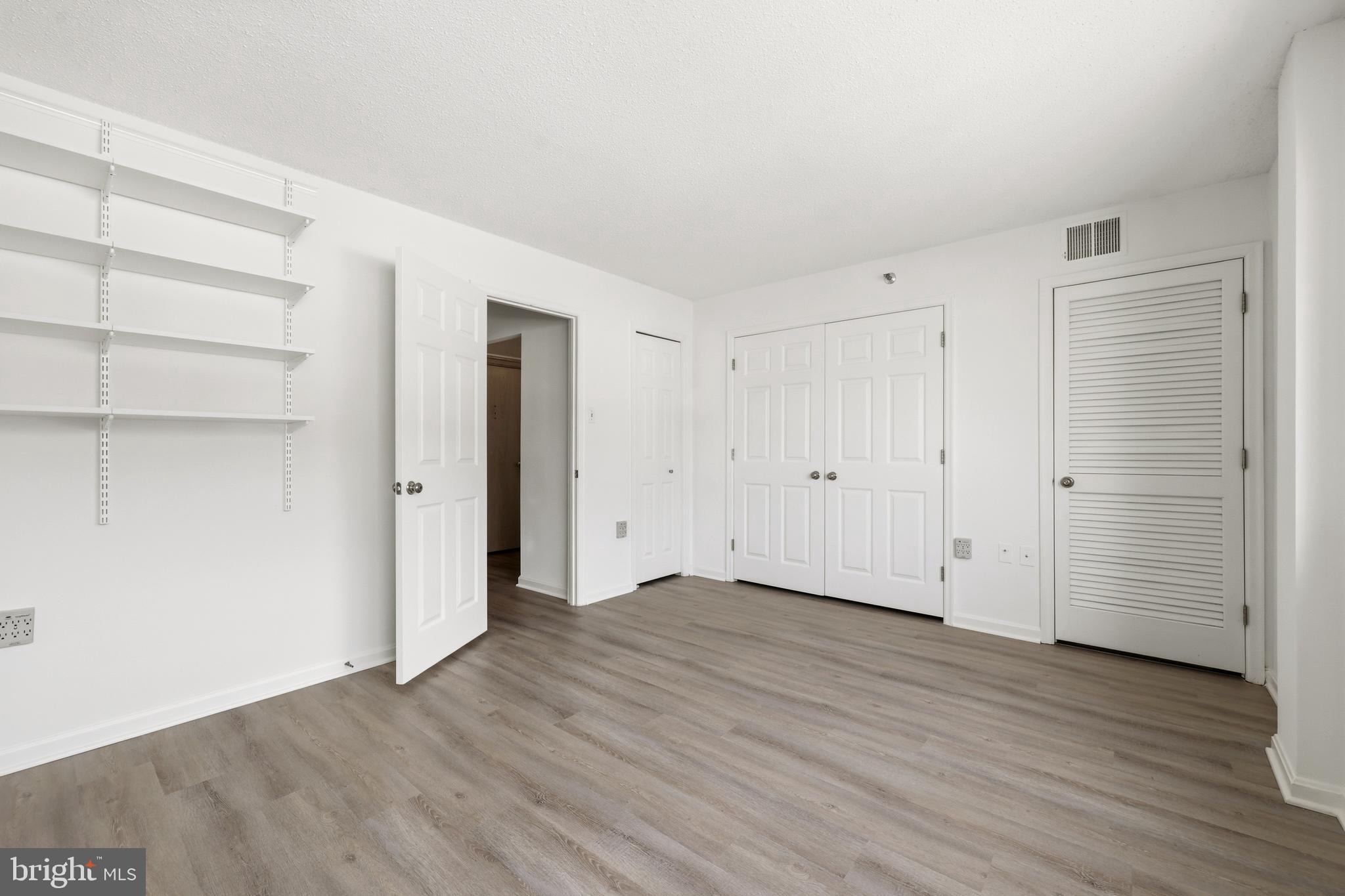 1301 North Courthouse Road, Unit 1205 Arlington, VA 22201 - Photo 14 of 33 a view of an empty room with wooden floor