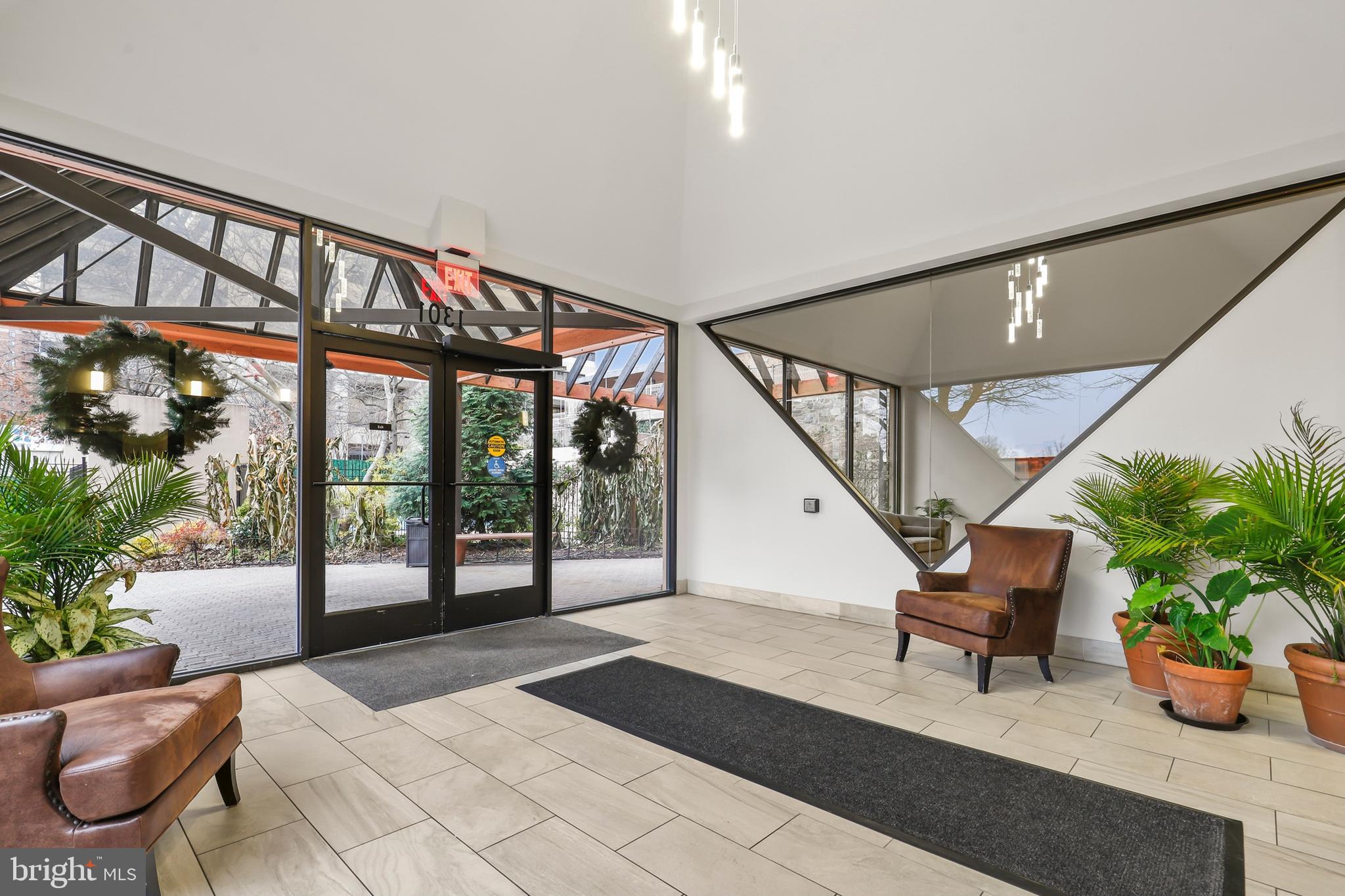 1301 North Courthouse Road, Unit 1205 Arlington, VA 22201 - Photo 22 of 33 a lobby with furniture and potted plant