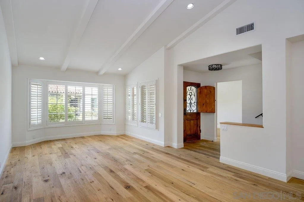 6125 La Flecha Rancho Santa Fe, CA 92067 - Photo 3 of 25 a view of an empty room with wooden floor and a window