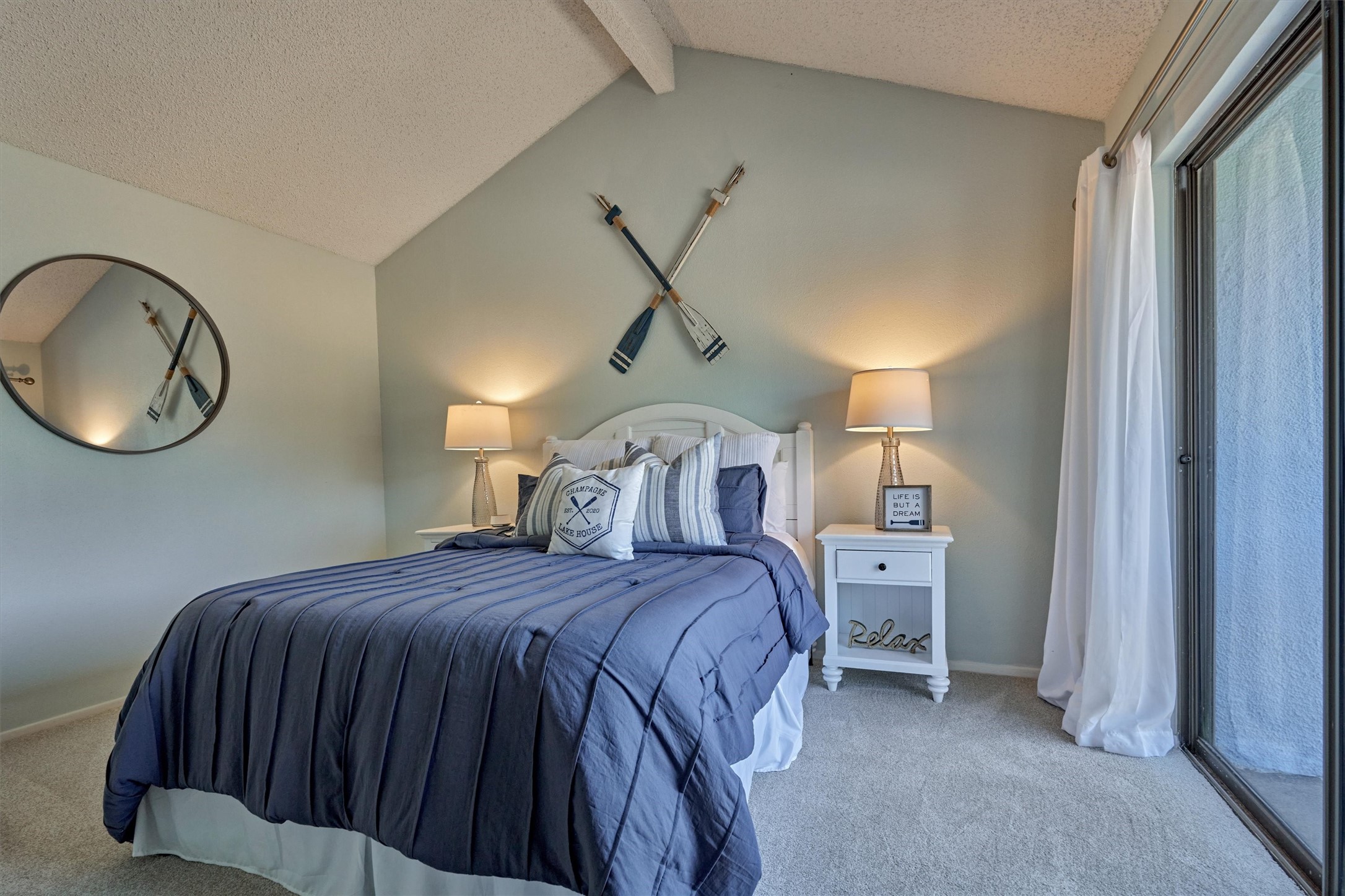 1428 Bowsprit Point Willis, TX 77318 - Photo 32 of 47 A guest bedroom on the second floor also features a vaulted ceiling and the calming blue wall color.