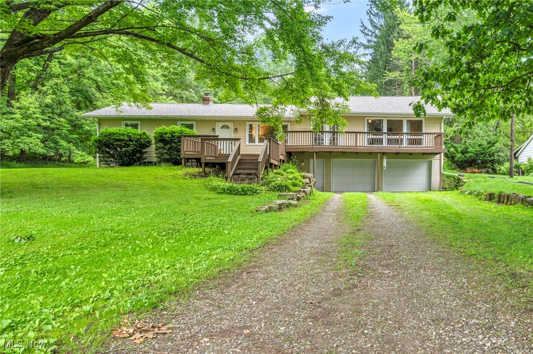3954 Homestead Road Ravenna, OH 44266 - Photo 2 of 46 Single story home featuring a deck, dirt driveway, a front lawn, and a chimney