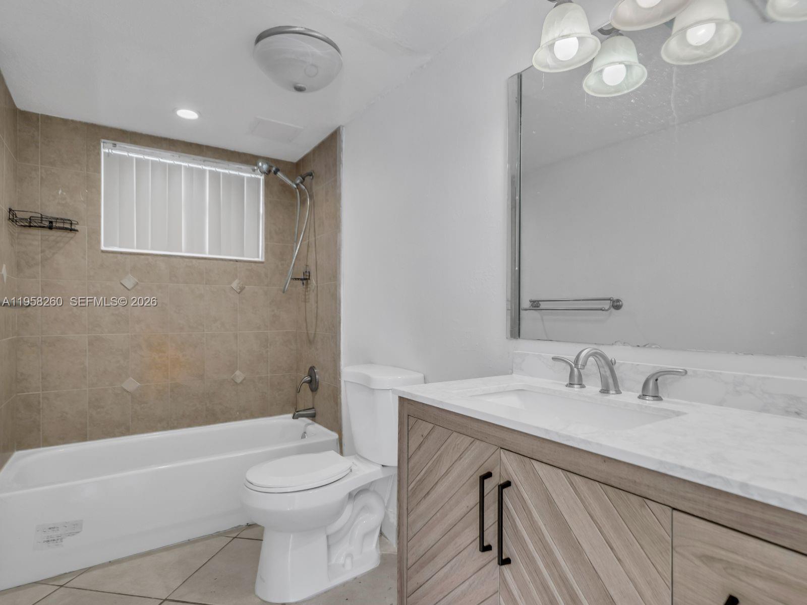 8601 Southwest 94th Street, Unit 104W Miami, FL 33156 - Photo 12 of 29 a bathroom with a sink a toilet and shower