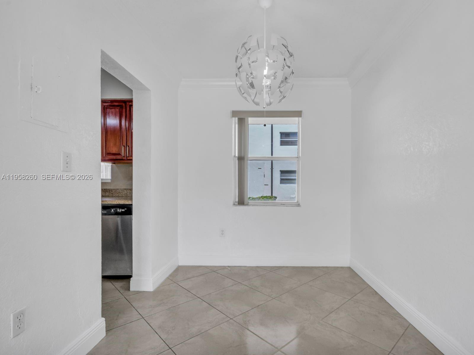 8601 Southwest 94th Street, Unit 104W Miami, FL 33156 - Photo 18 of 29 an empty room with chandelier