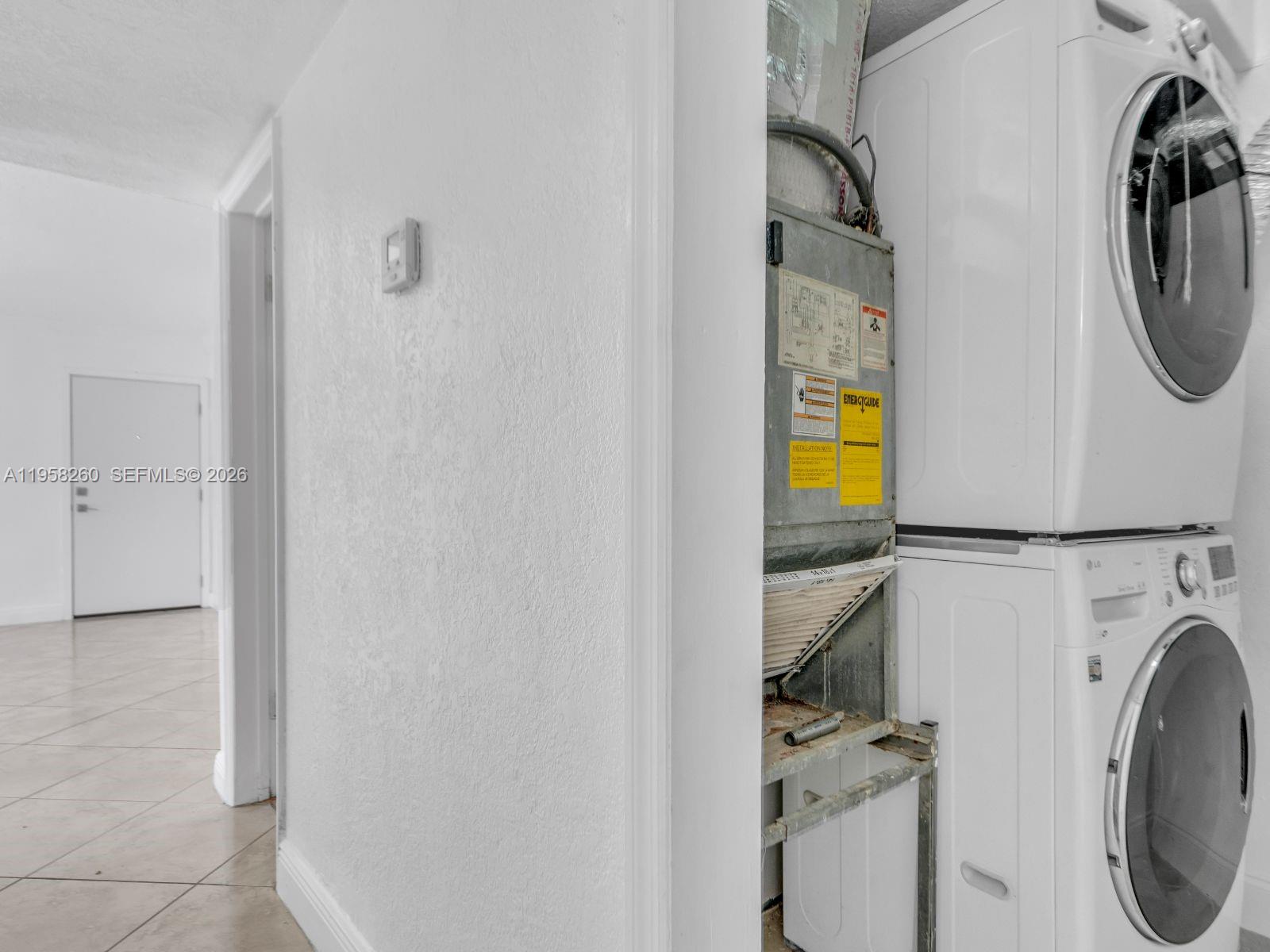 8601 Southwest 94th Street, Unit 104W Miami, FL 33156 - Photo 5 of 29 a view of a storage & utility room with washer and dryer