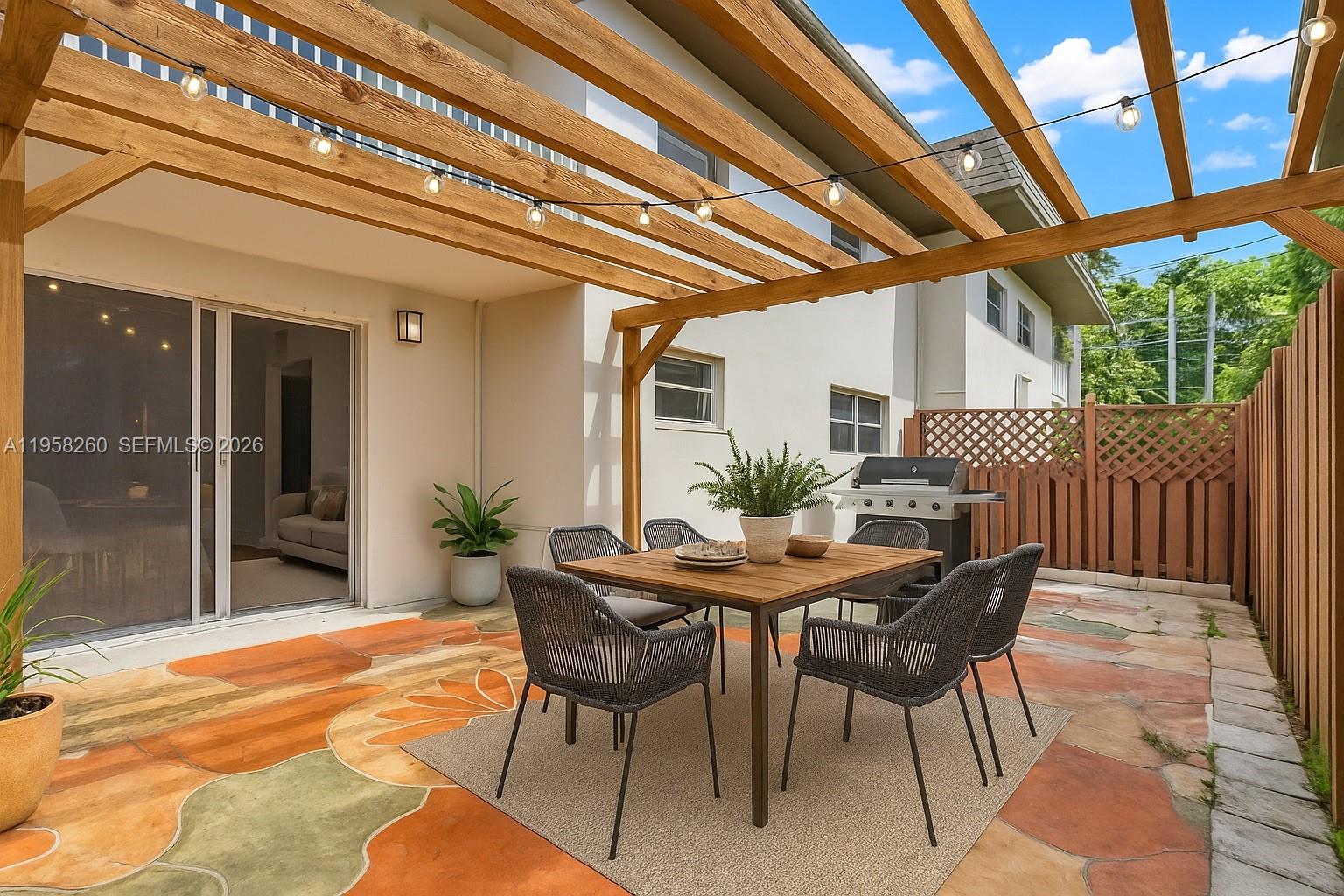 8601 Southwest 94th Street, Unit 104W Miami, FL 33156 - Photo 7 of 29 a view of an outdoor dining space with furniture and wooden floor