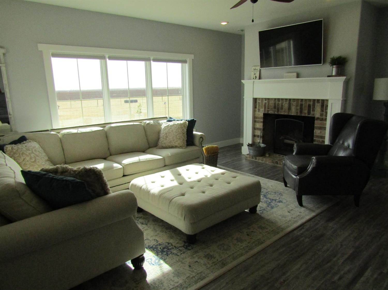 3370 Drill Stem Road Levelland, TX 79336 - Photo 2 of 38 a living room with furniture a flat screen tv and a fireplace