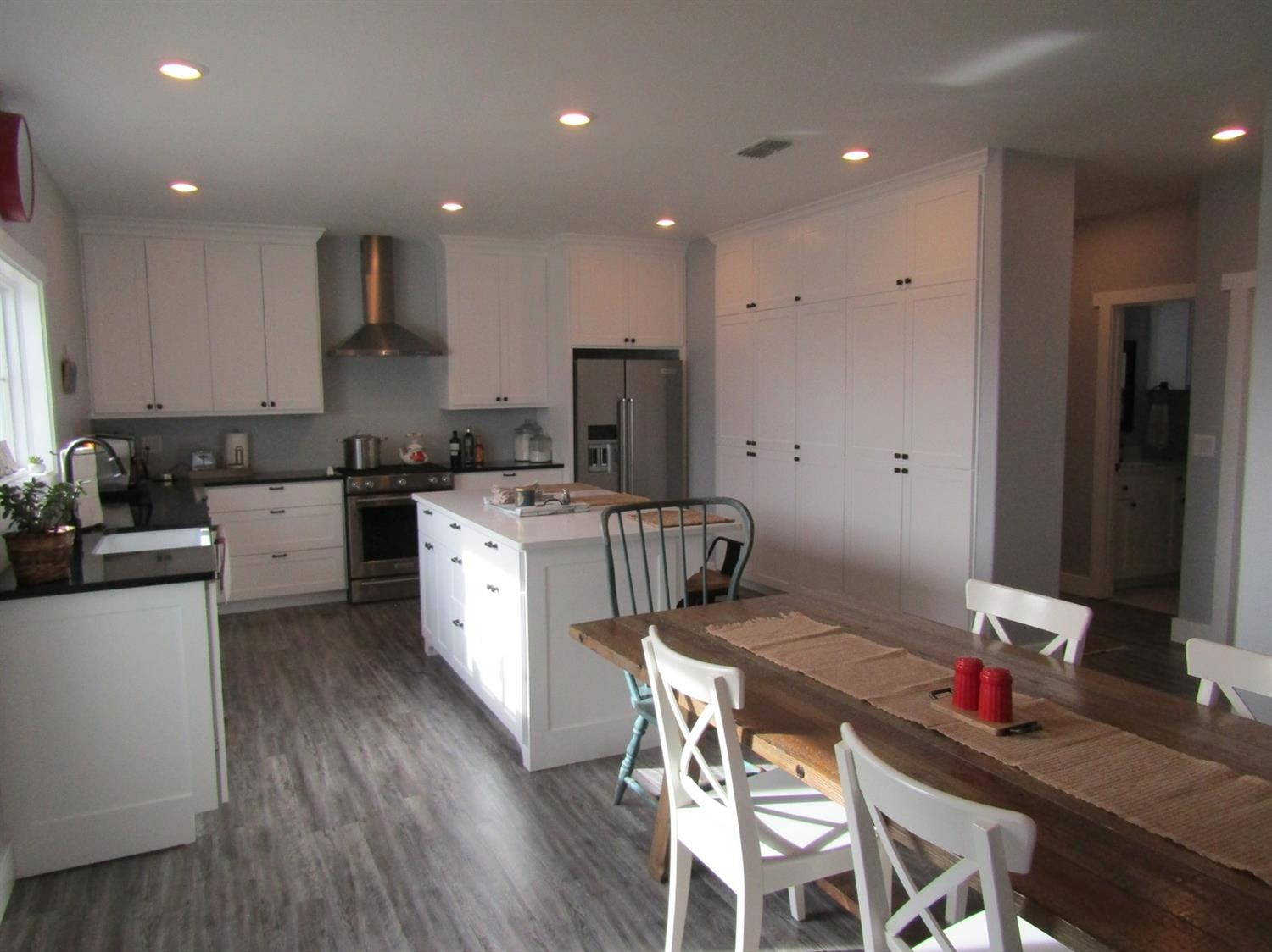 3370 Drill Stem Road Levelland, TX 79336 - Photo 4 of 38 a kitchen with a sink a stove a refrigerator cabinets and wooden floor