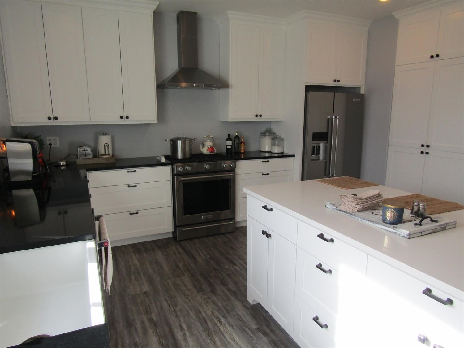 3370 Drill Stem Road Levelland, TX 79336 - Photo 6 of 38 a kitchen with refrigerator cabinets and wooden floor