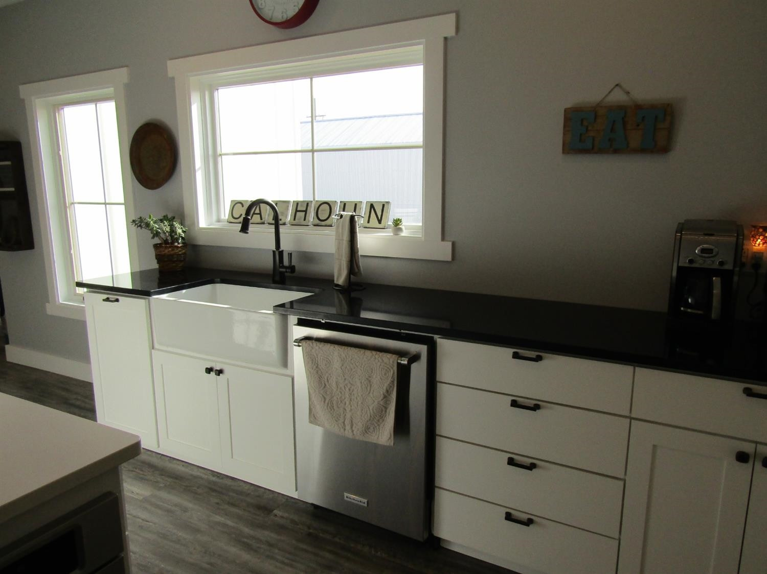 3370 Drill Stem Road Levelland, TX 79336 - Photo 8 of 38 a kitchen with a window wooden floor and a sink