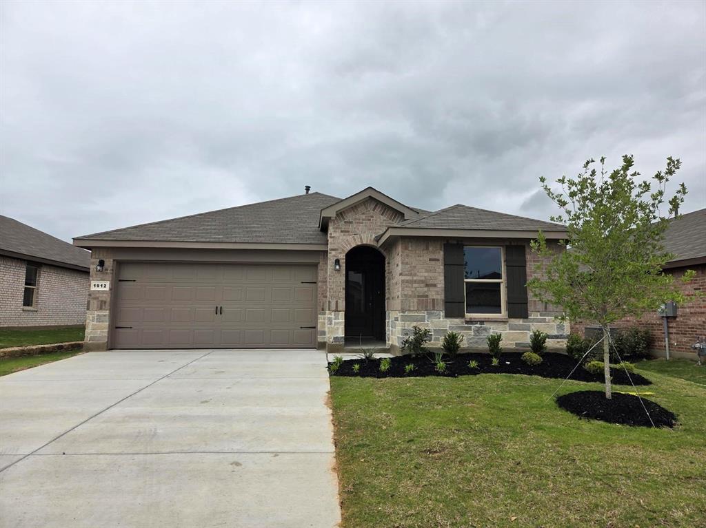 1914 Cherokee Lane Cleburne, TX 76033 - Photo 1 of 2 a front view of a house with garden
