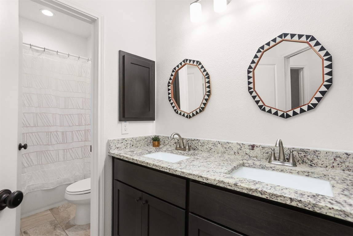 3403 Daisy Santa Fe, TX 77510 - Photo 18 of 25 a bathroom with a granite countertop sink a toilet and a mirror