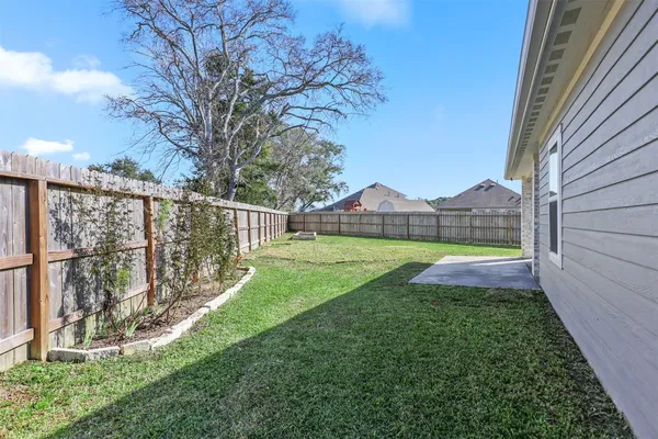 a view of yard with wooden fence