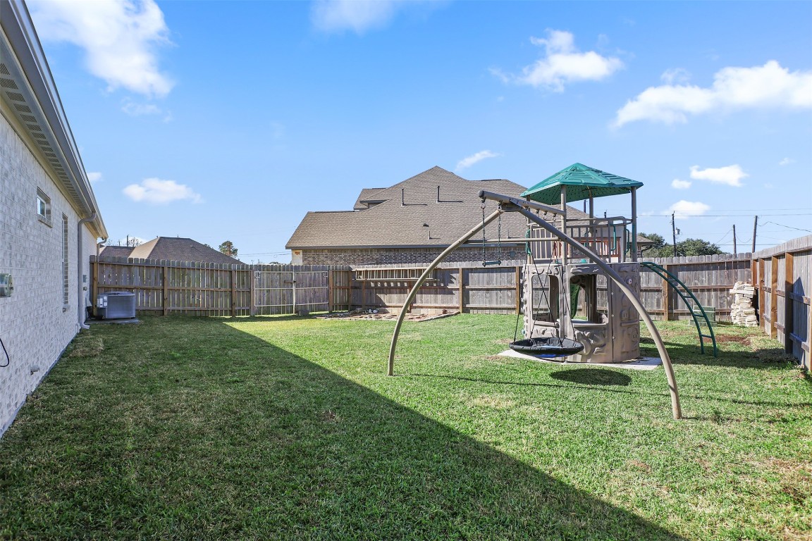 3403 Daisy Santa Fe, TX 77510 - Photo 24 of 25 a view of a house with backyard and a slide