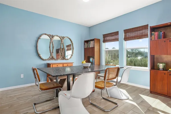 a room with furniture and large windows