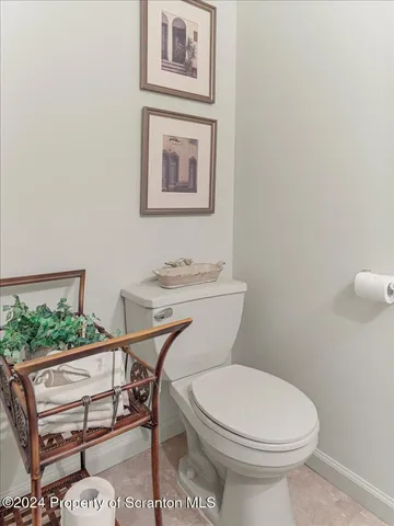 a dining room with furniture a chandelier and wooden floor