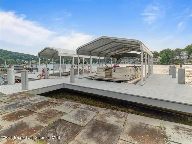 a view of a roof deck with couches and sky view