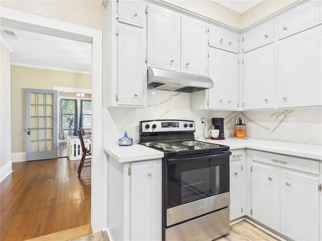 a kitchen with stainless steel appliances granite countertop a sink and cabinets