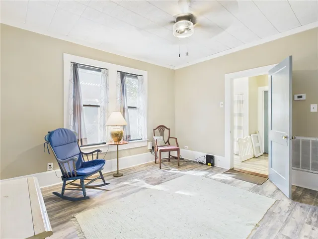 a kitchen with a refrigerator a sink and white cabinets with wooden floor