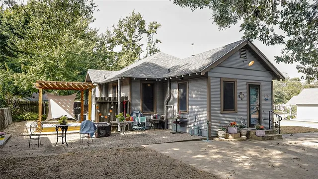 a dining room with furniture a potted plant and wooden floor