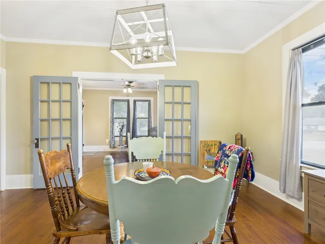 a view of a dining room with furniture and a chandelier