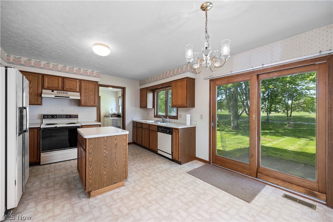 722 Jaycox Road Avon Lake, OH 44012 - Photo 6 of 48 Kitchen featuring wood cabinetry, white countertops, and a central island