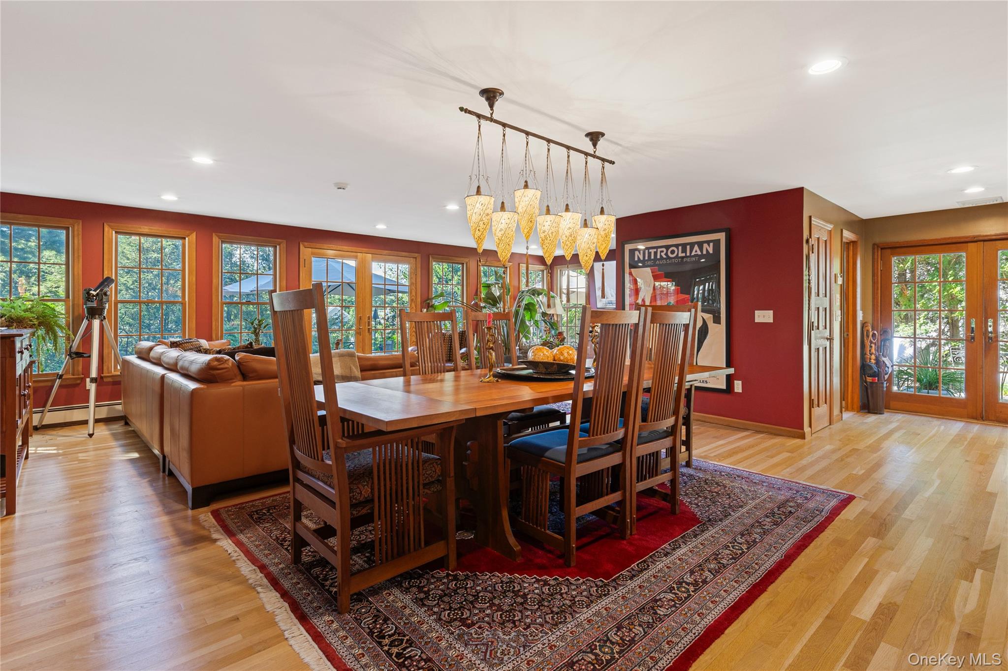 46 Hill Street Rye, NY 10580 - Photo 13 of 30 a dining room with wooden floor a chandelier a wooden table and chairs