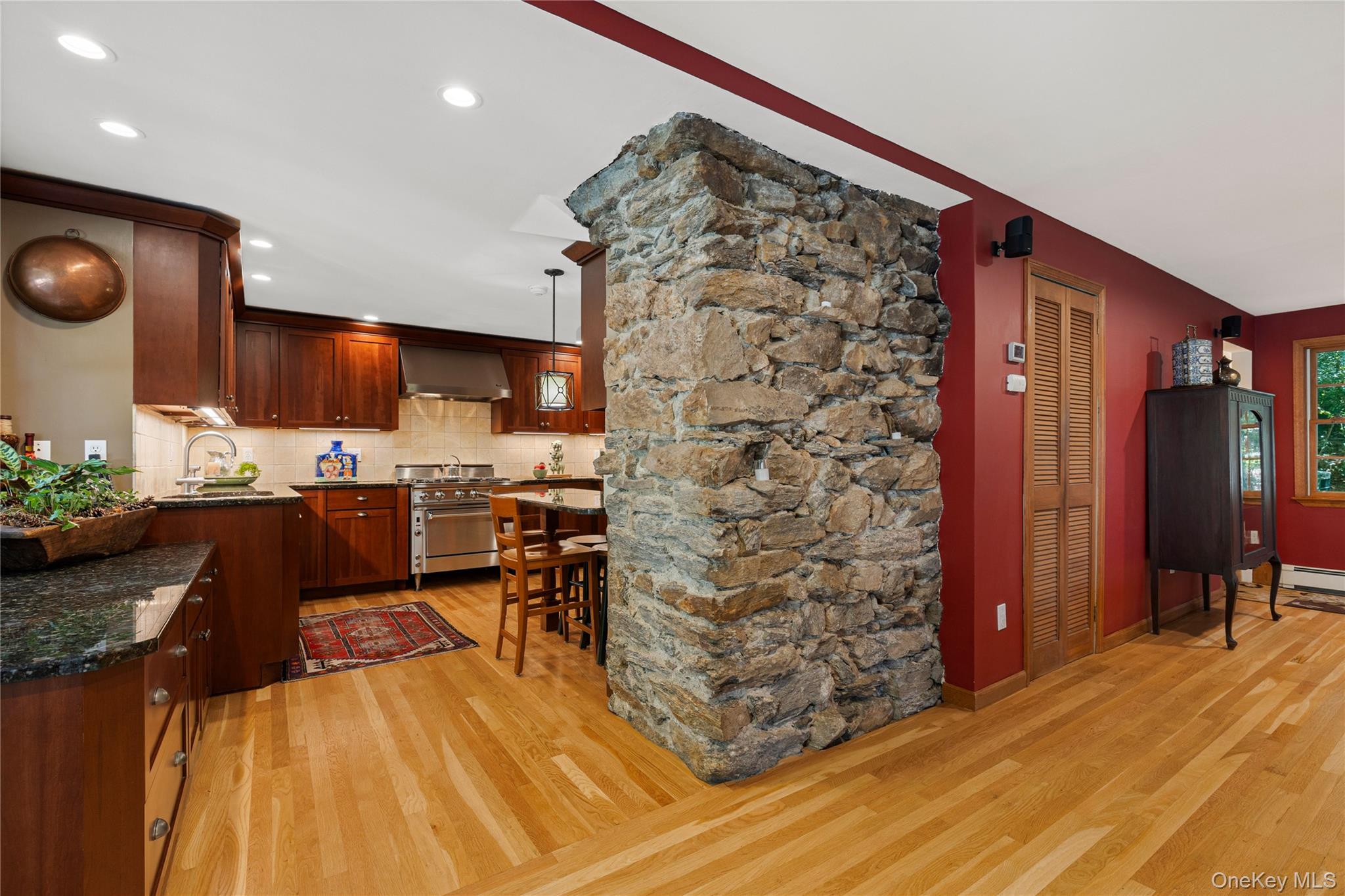 46 Hill Street Rye, NY 10580 - Photo 17 of 30 a open kitchen with stainless steel appliances kitchen island granite countertop a refrigerator stove oven dining table and chairs