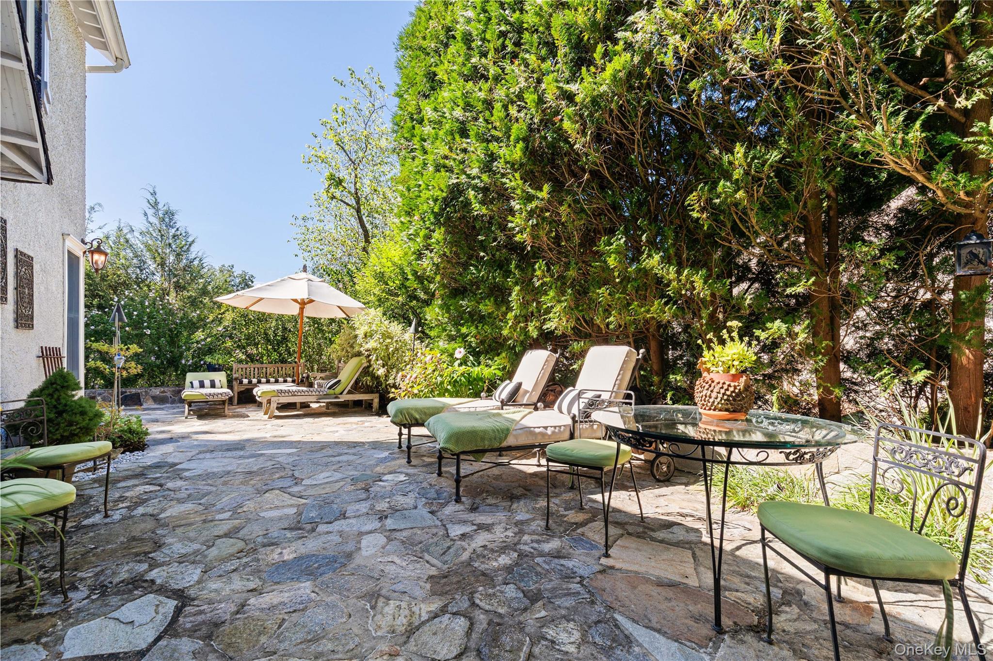 46 Hill Street Rye, NY 10580 - Photo 21 of 30 a backyard of a house with table and chairs