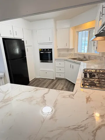 a view of a kitchen with wooden floor
