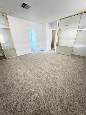 a bathroom with a tub sink vanity and a mirror