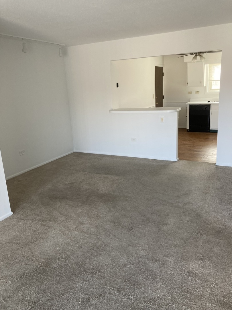 718 Cobblestone Circle, Unit D Glenview, IL 60025 - Photo 2 of 9 a view of an empty room with a window