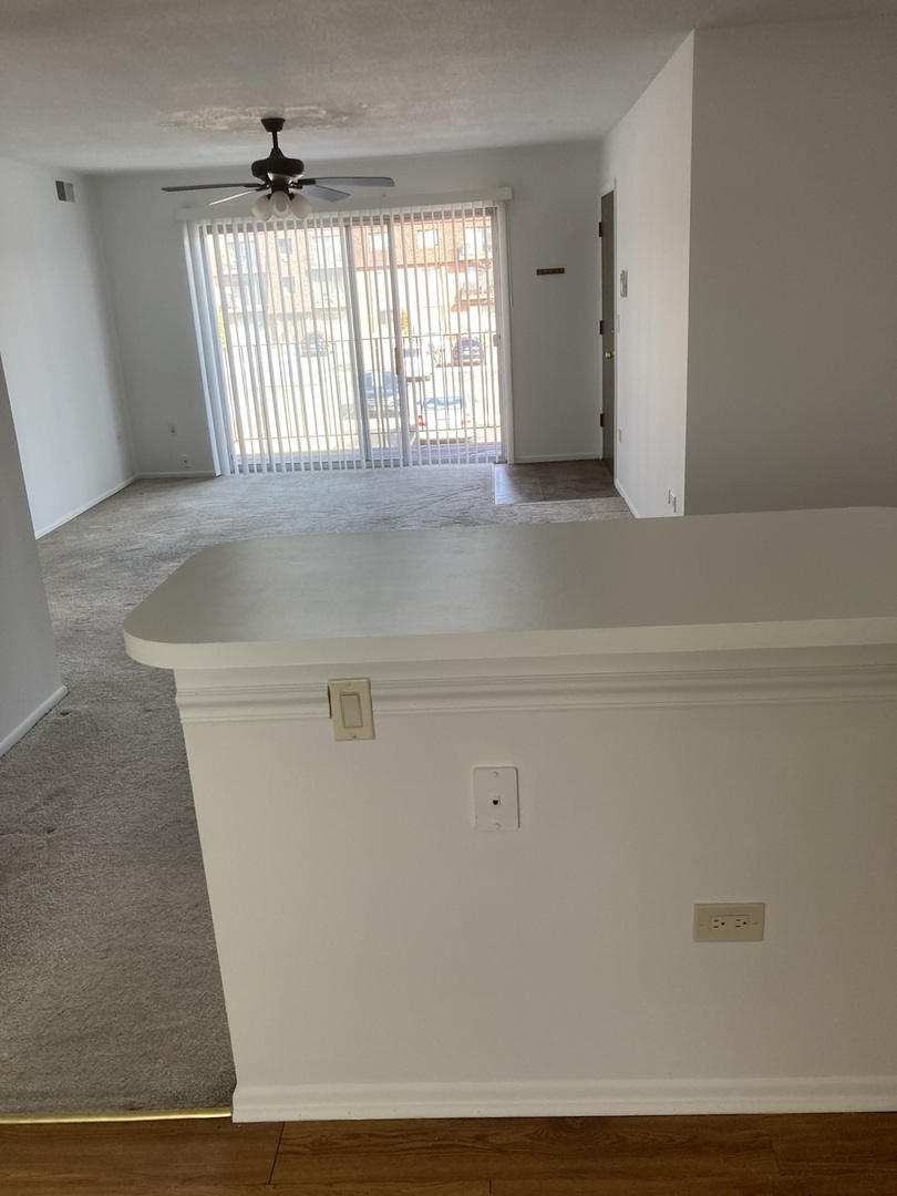 718 Cobblestone Circle, Unit D Glenview, IL 60025 - Photo 3 of 9 a view of an empty room with a window