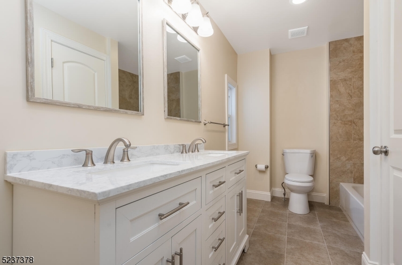 13 Maple Street Milford, NJ 08848 - Photo 11 of 20 a bathroom with a toilet a sink a and mirror