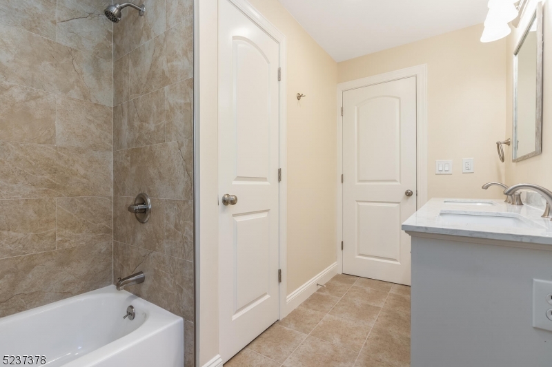 13 Maple Street Milford, NJ 08848 - Photo 12 of 20 a bathroom with a sink a mirror and a bathtub