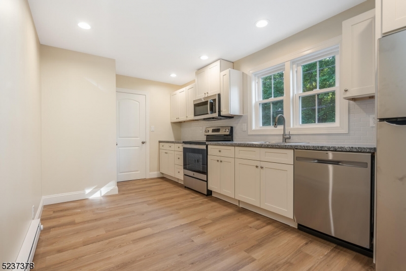 13 Maple Street Milford, NJ 08848 - Photo 13 of 20 a kitchen with granite countertop a stove a sink and a refrigerator