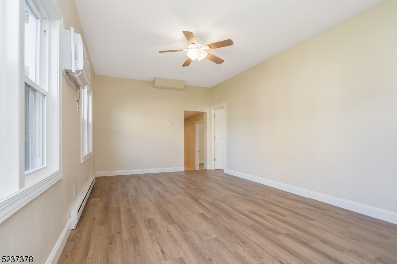 13 Maple Street Milford, NJ 08848 - Photo 3 of 20 a view of an empty room with wooden floor and a window