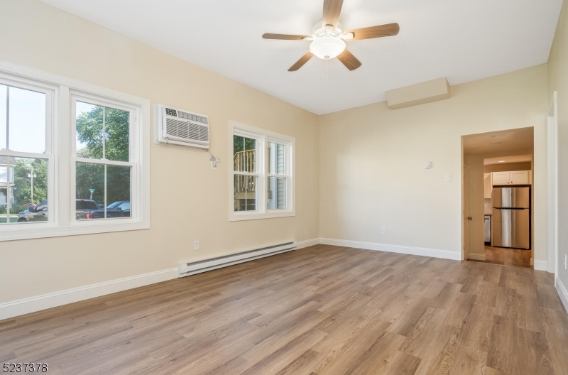 13 Maple Street Milford, NJ 08848 - Photo 4 of 20 a view of empty room with wooden floor and fan