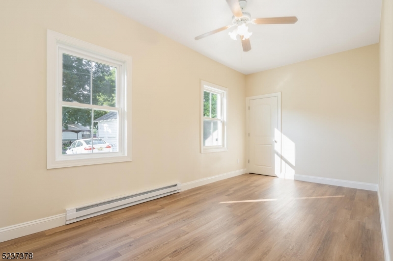 13 Maple Street Milford, NJ 08848 - Photo 6 of 20 a view of an empty room with wooden floor and a window