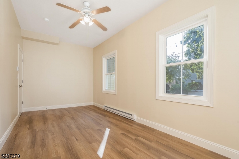 13 Maple Street Milford, NJ 08848 - Photo 7 of 20 a view of empty room with wooden floor and fan