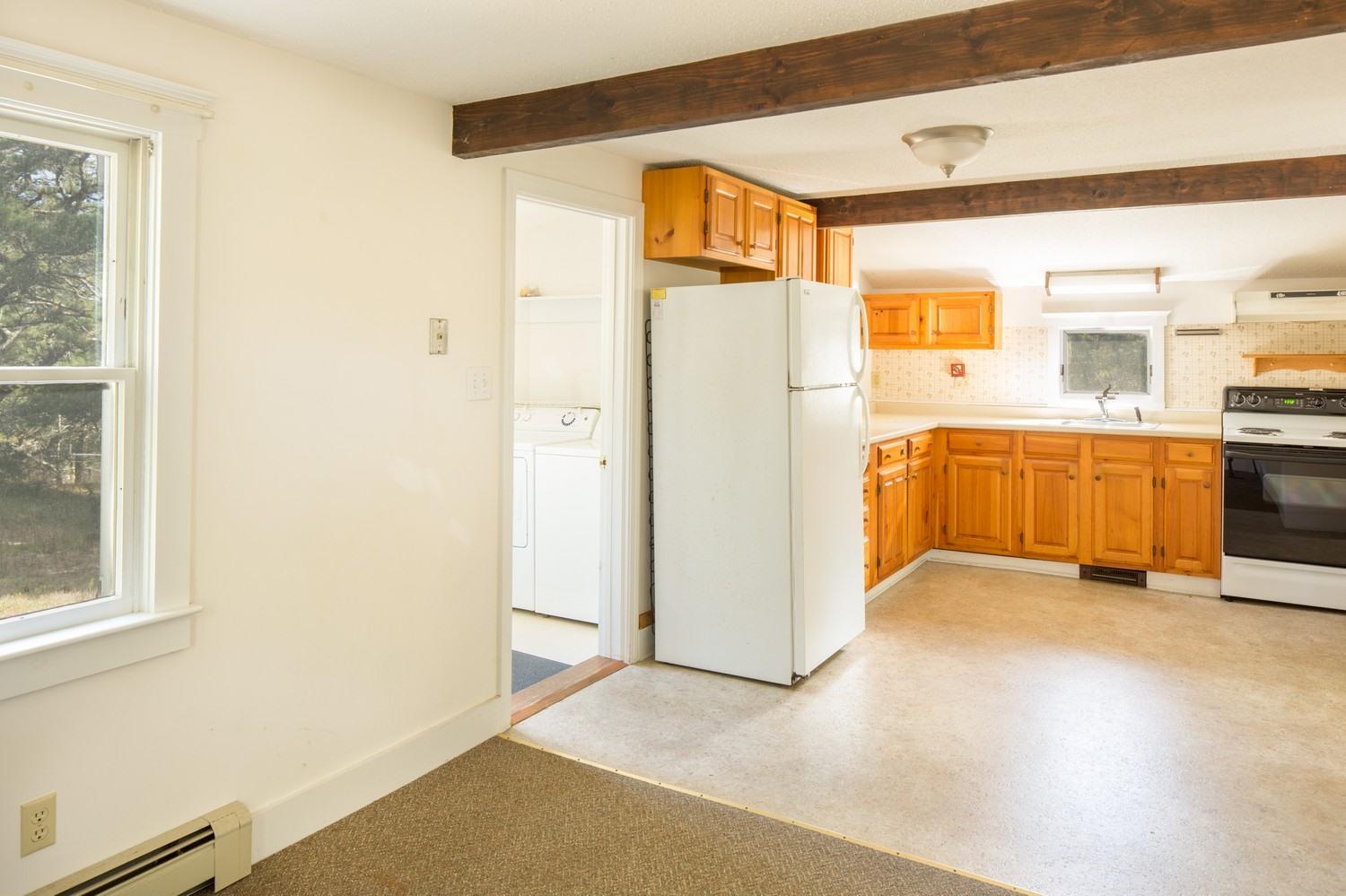 59 South Pamet Road Truro, MA 02666 - Photo 11 of 15 a view of a kitchen with a sink and a refrigerator