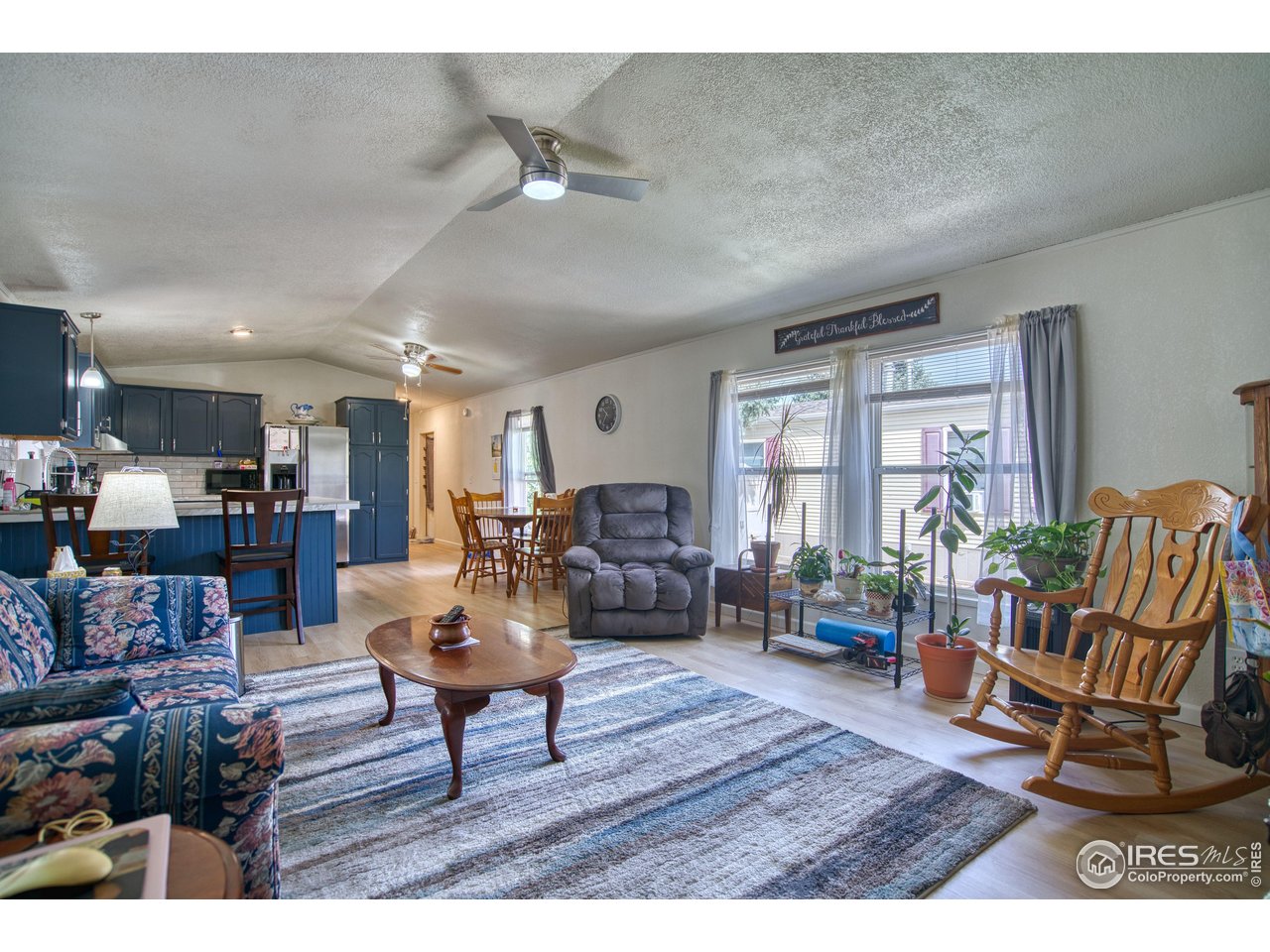 230 North 2nd Street, Unit 26 Berthoud, CO 80513 - Photo 2 of 17 a living room with furniture and wooden floor