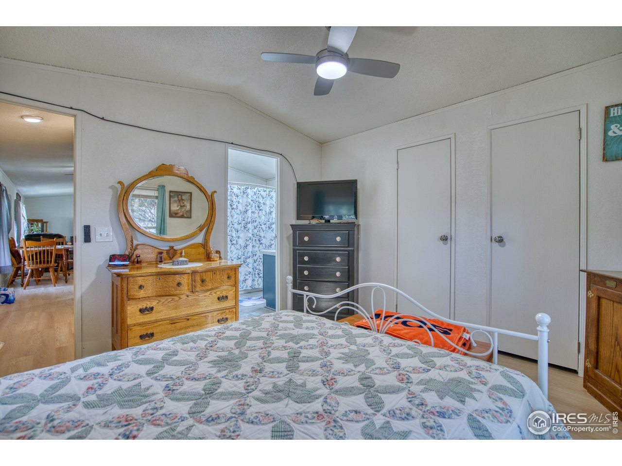 230 North 2nd Street, Unit 26 Berthoud, CO 80513 - Photo 9 of 17 a bedroom with a bed and a chandelier