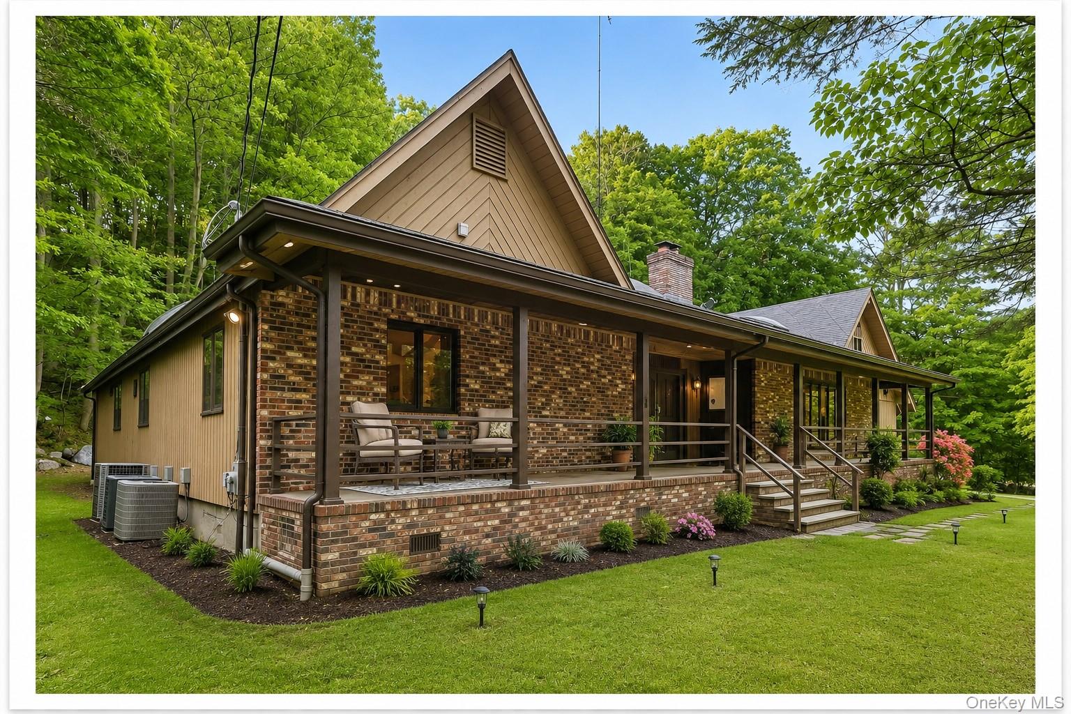 Brick and siding exterior with a covered front porch featuring multiple seating areas