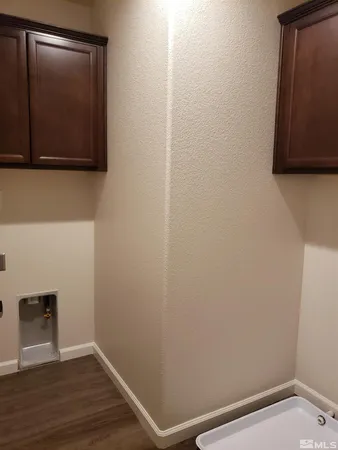 a view of a small space with wooden floor and a window