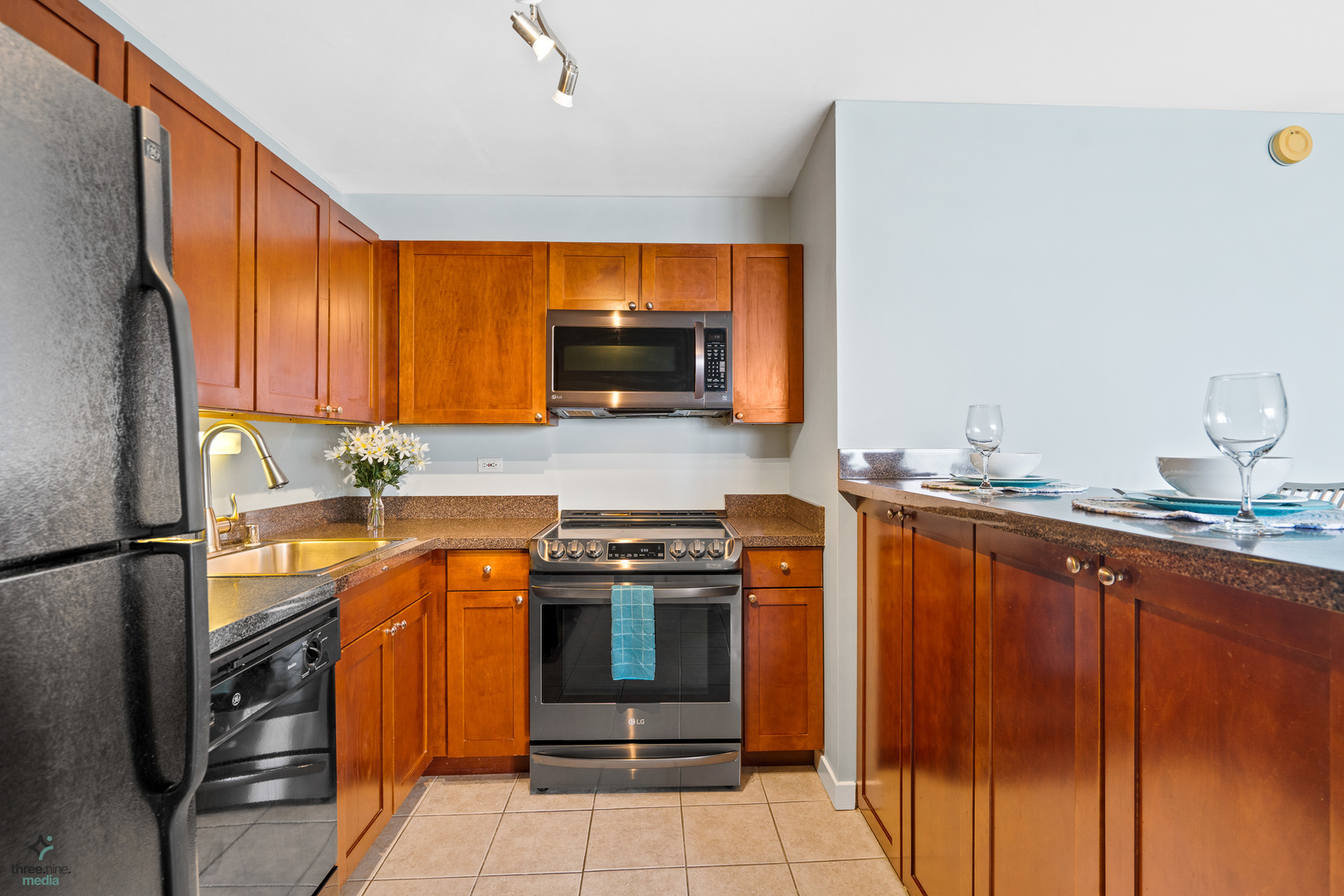 655 West Irving Park Road, Unit 3214 Chicago, IL 60613 - Photo 12 of 37 a kitchen with stainless steel appliances granite countertop a stove a sink and a refrigerator